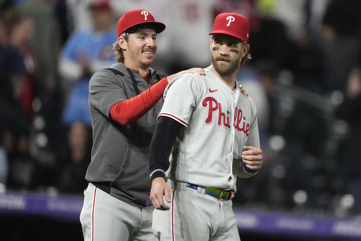 Philadelphia Phillies' Bryson Stott, left, congratulates Bryce Harper after a baseball game aga ...