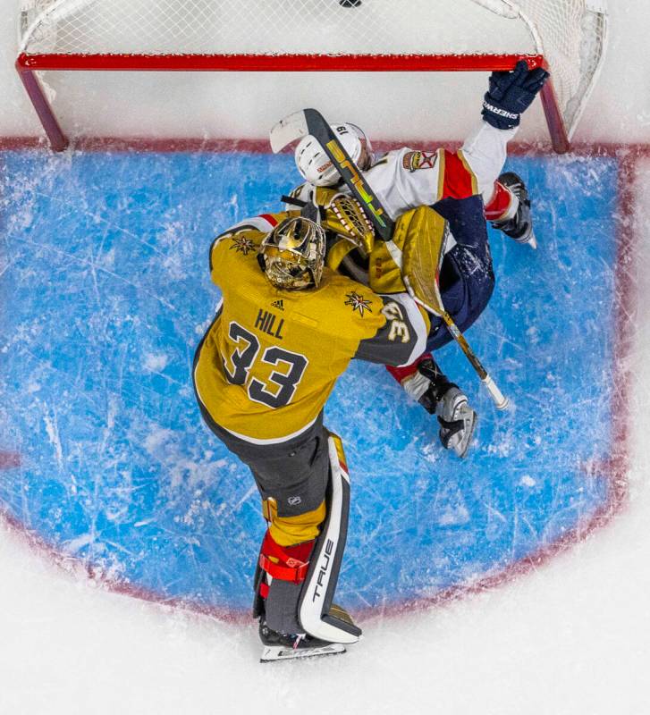 Golden Knights goaltender Adin Hill (33) smashes Florida Panthers left wing Matthew Tkachuk (19 ...