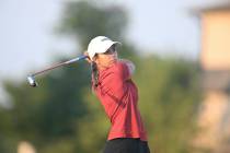 Yana Wilson hits her drive to kick off her match against Gianna Clemente during the final match ...