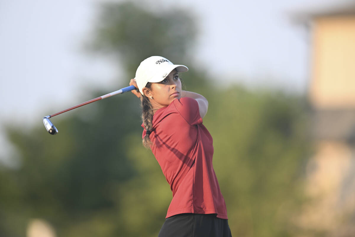 Yana Wilson hits her drive to kick off her match against Gianna Clemente during the final match ...