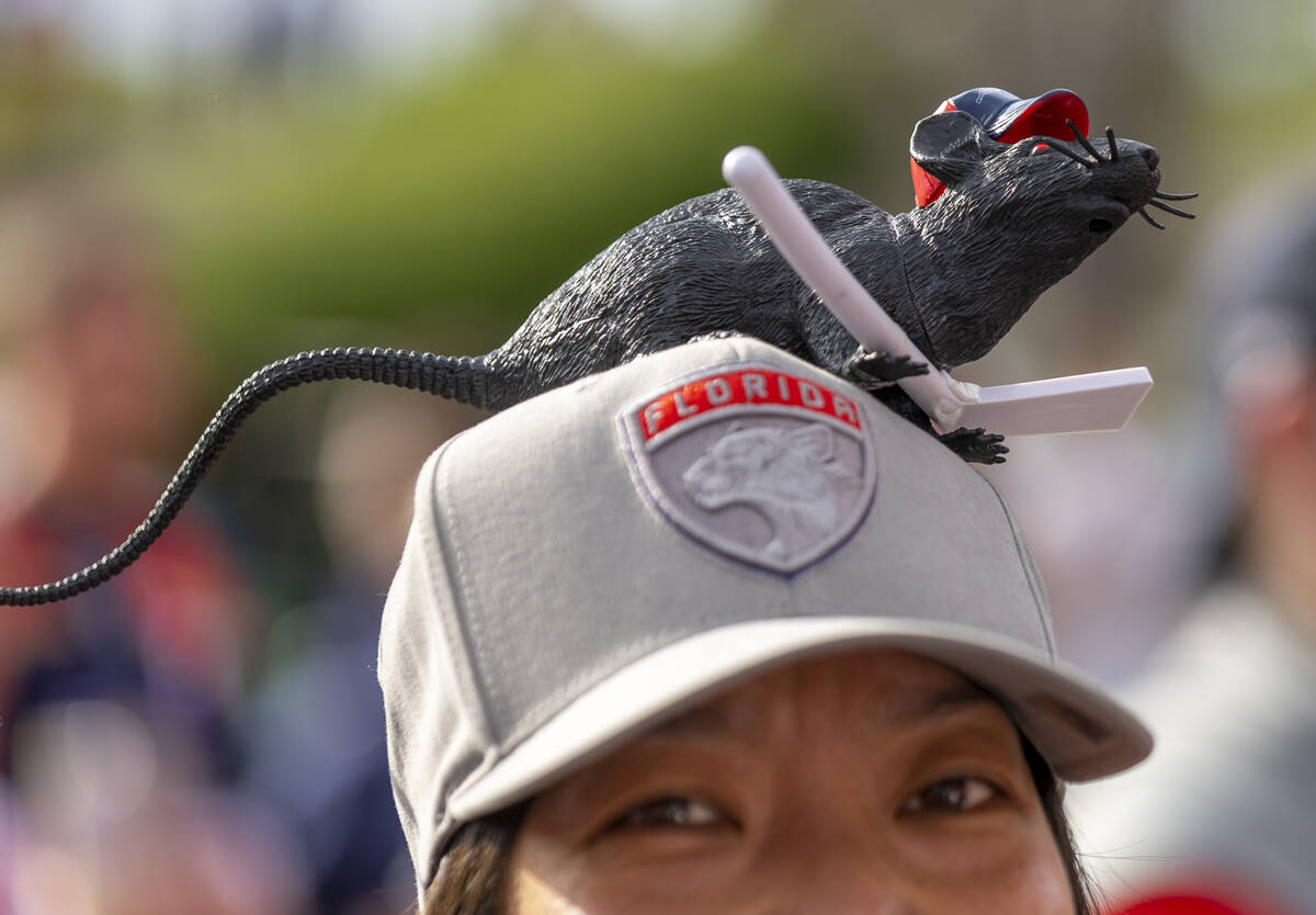 A Florida Panthers fan sports a rat on her hat as she enjoys some music before Game 3 of the NH ...