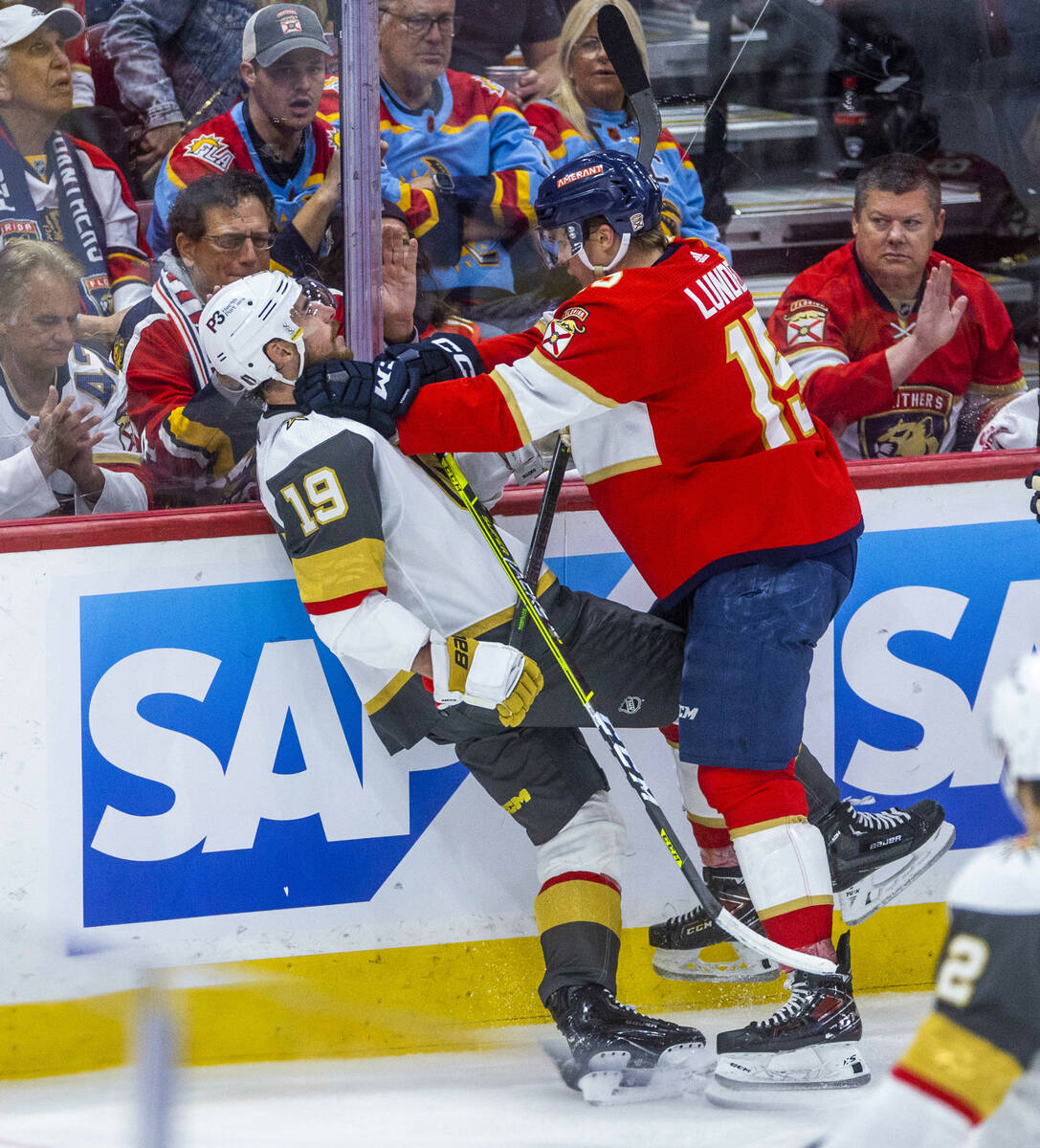Golden Knights right wing Reilly Smith (19) is choked by Florida Panthers center Anton Lundell ...