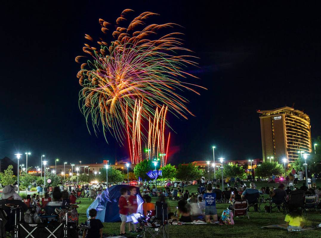 In this July 4, 2020, file photo, people watch the Red Rock Casino fireworks show from Downtown ...