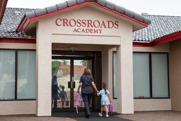 A girl is dropped off at the Crossroads Academy preschool on Wednesday, June 7, 2023, in Las Ve ...
