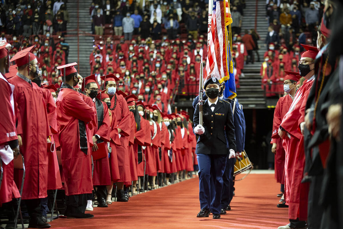 Graduates turn to face the Army ROTC Color Guard as they enter the UNLV Winter 2021 commencemen ...