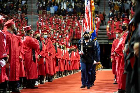 Graduates turn to face the Army ROTC Color Guard as they enter the UNLV Winter 2021 commencemen ...