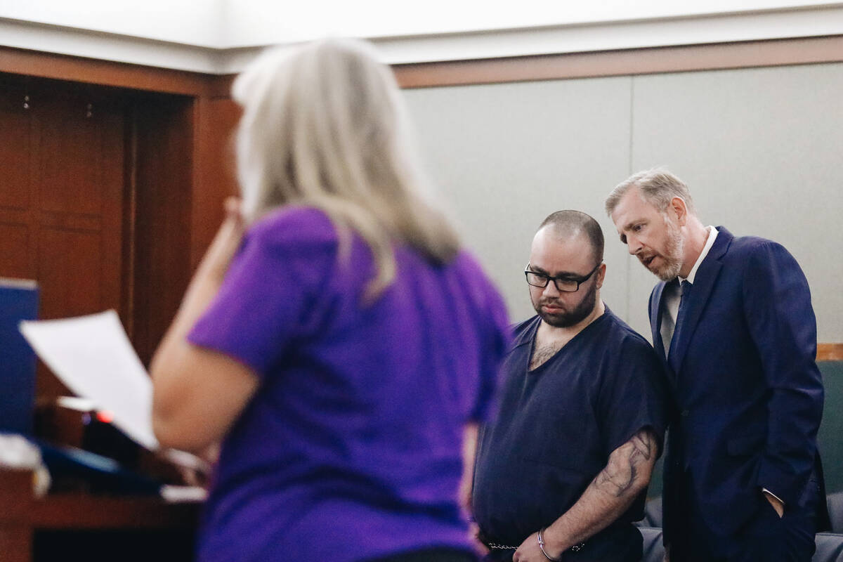 Philip O’Reilly, left, lean in to listen to Chief Deputy Public Defender David Westbrook as S ...