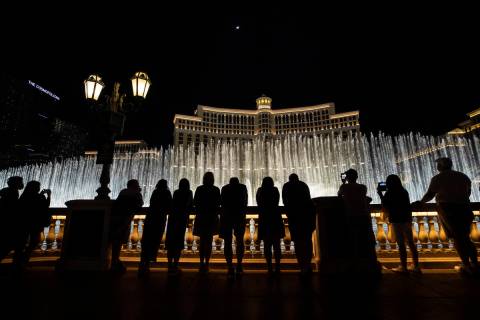 Visitors enjoy the Fountains of Bellagio show on March 19, 2021, in Las Vegas. The Bellagio's r ...
