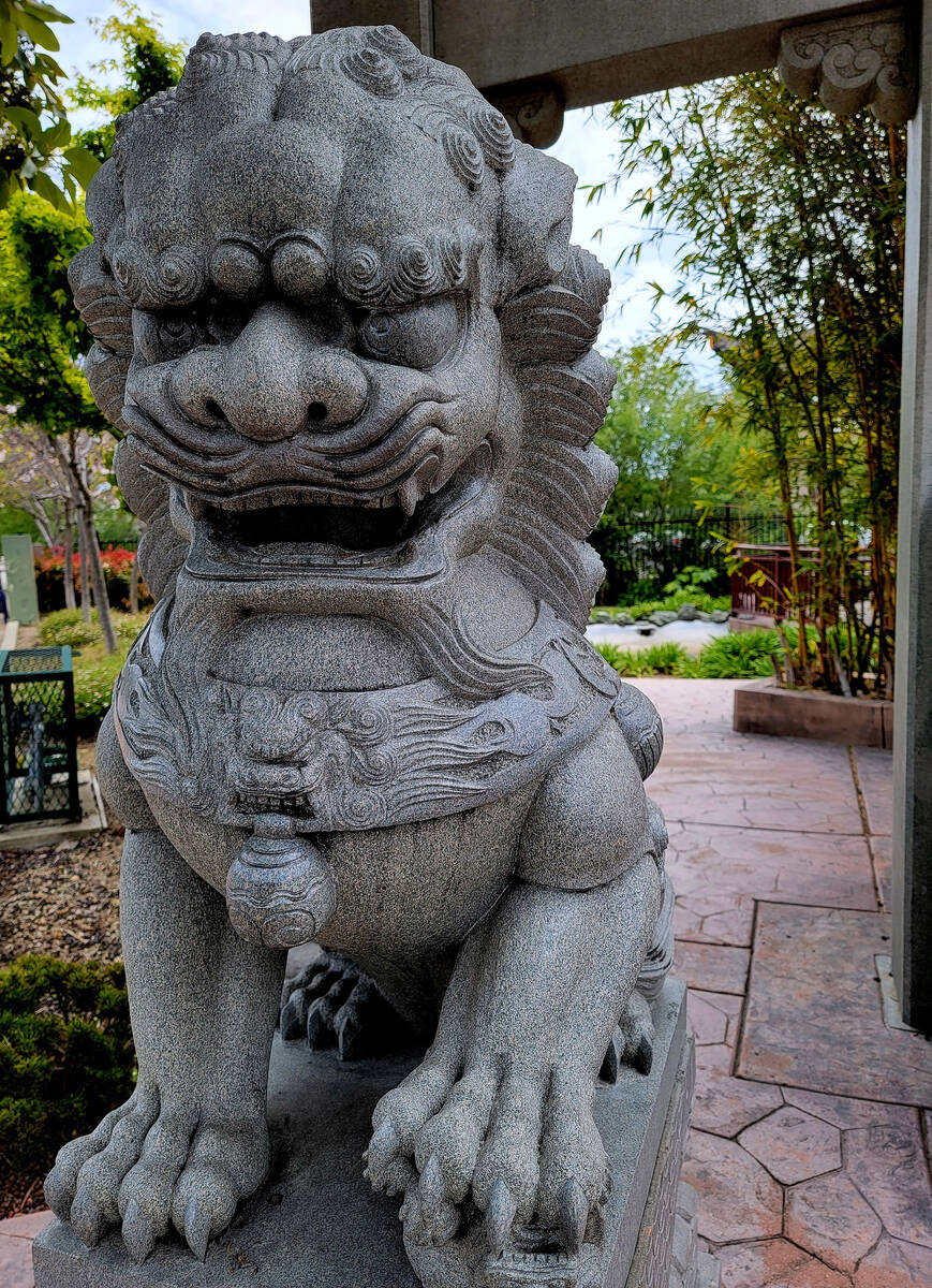 One of a pair of stone lions guarding the entrance of Cheng Park in the very walkable downtown ...