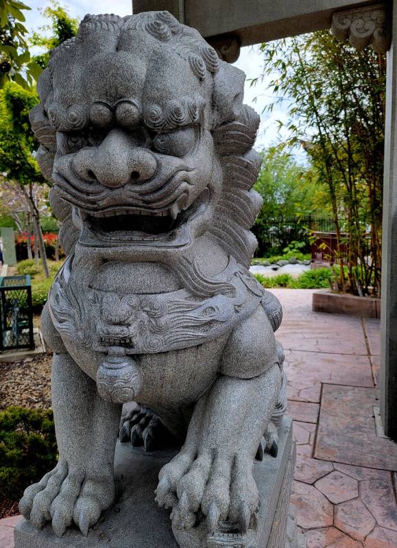 One of a pair of stone lions guarding the entrance of Cheng Park in the very walkable downtown ...