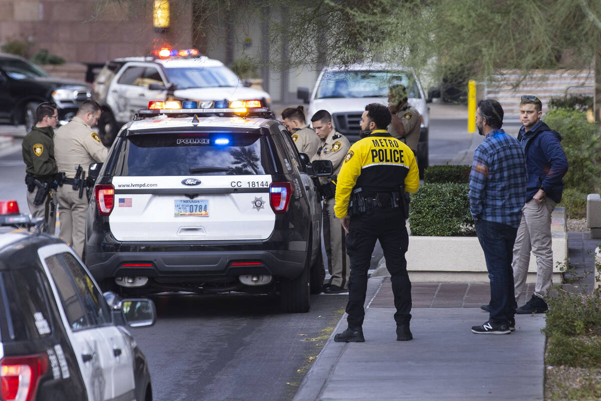 In this Dec. 31, 2021, file photo, Las Vegas police investigate a robbery and shooting in the p ...
