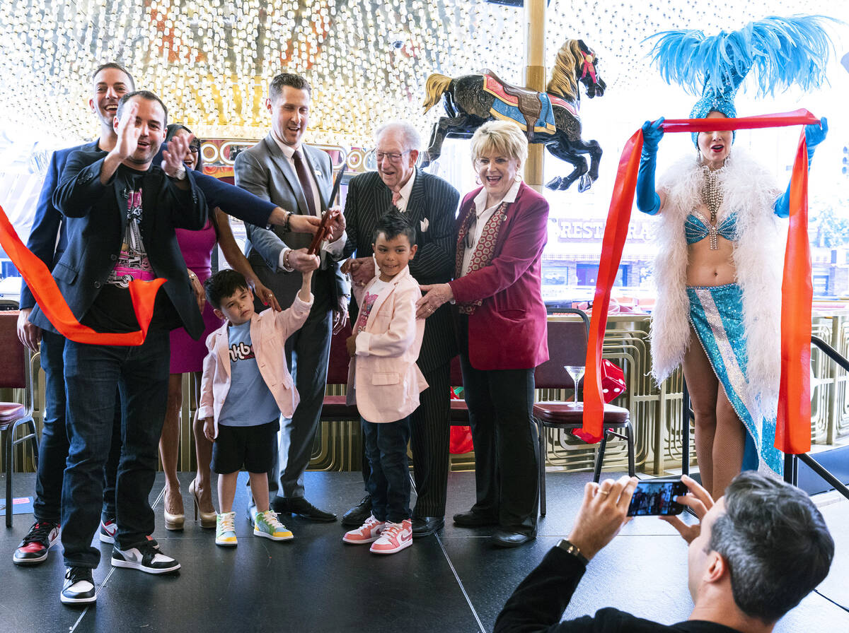 Plaza hotel and casino CEO Jonathan Jossel, center, former Las Vegas Mayor Oscar Goodman and hi ...