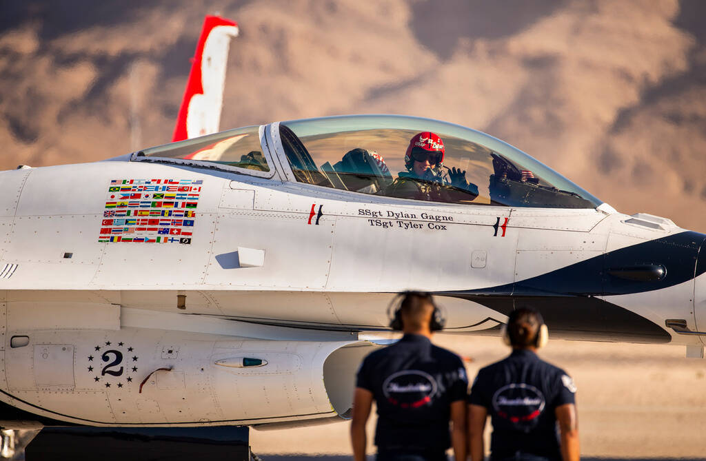 Lt. Col. John Caldwell of the U.S. Air Force Thunderbirds waves to the crowd as he taxis his ai ...