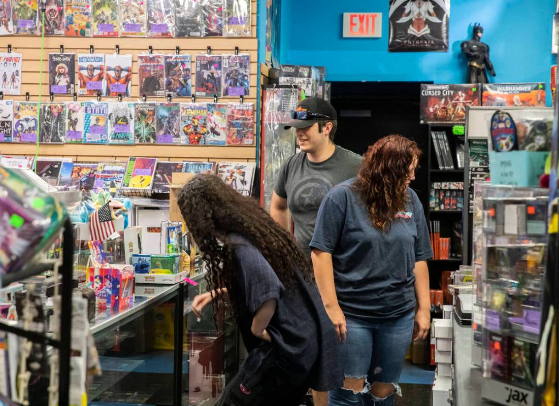 Customers peruse through a vast collection of comics at Action Comics and Games along the Bould ...