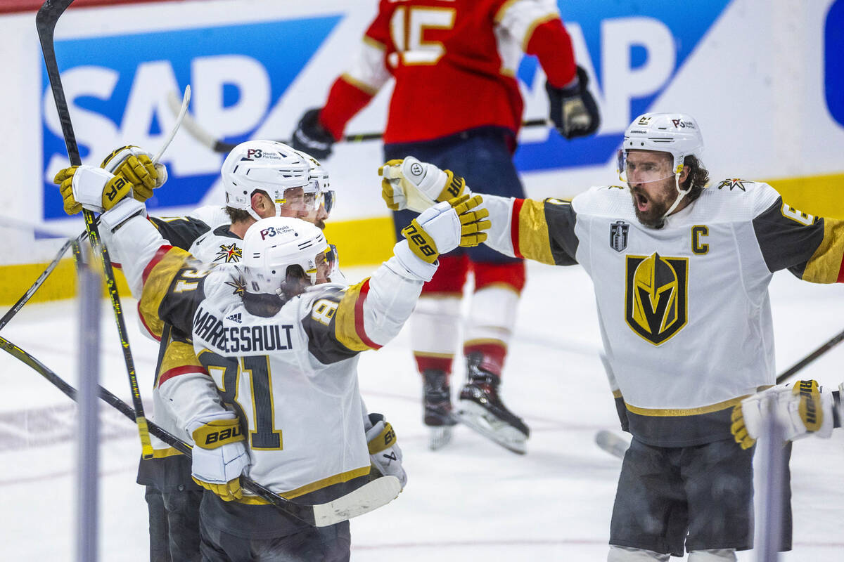 Golden Knights right wing Mark Stone (61) comes to celebrate a goal with right wing Jonathan Ma ...