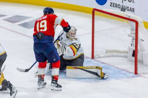 Golden Knights goaltender Adin Hill (33) looks back as a goal hits the net with Florida Panther ...