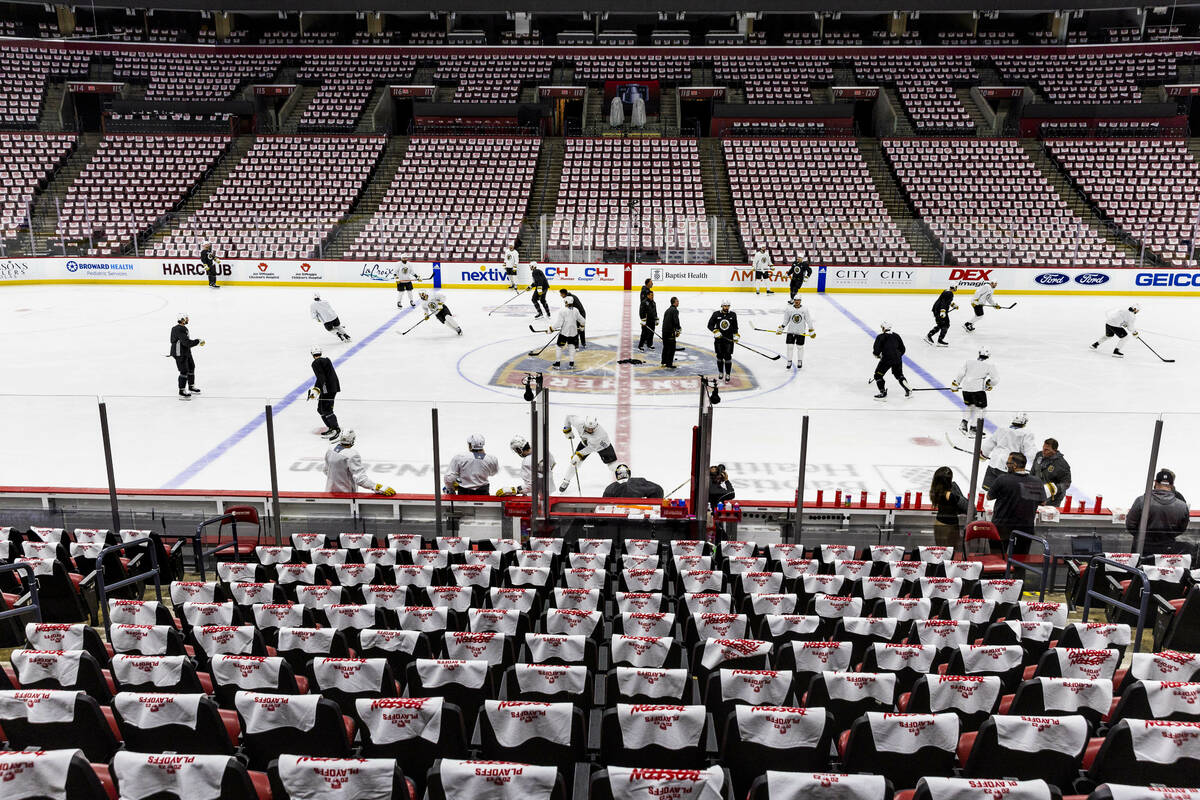 Golden Knights players skate on the ice as towels are hung on the seats during the morning skat ...