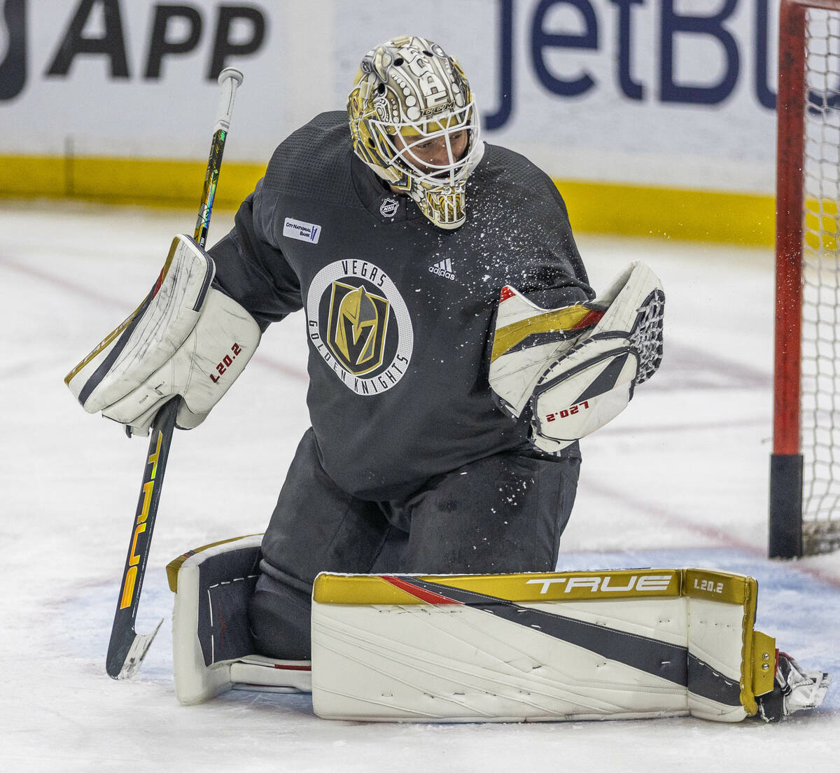 Golden Knights goaltender Adin Hill (33) catches a puck as ice from it flies off during the mor ...