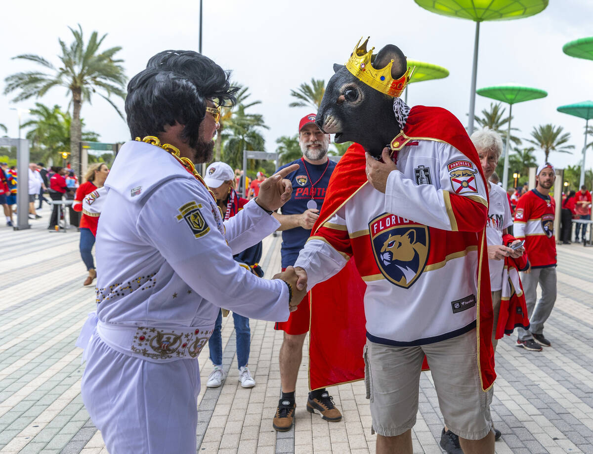 Elvis from Vegas chats with the Rat King from Florida loose for a photo outside before Game 4 o ...