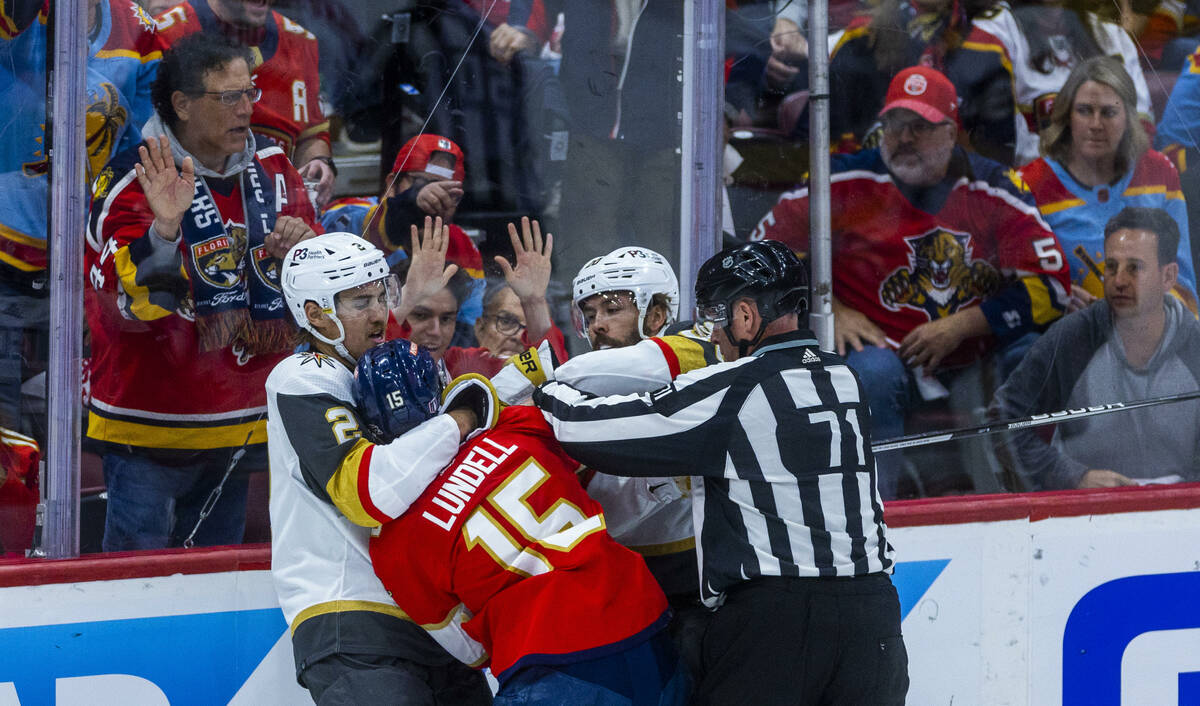 Golden Knights defenseman Zach Whitecloud (2) fights with Florida Panthers center Anton Lundell ...