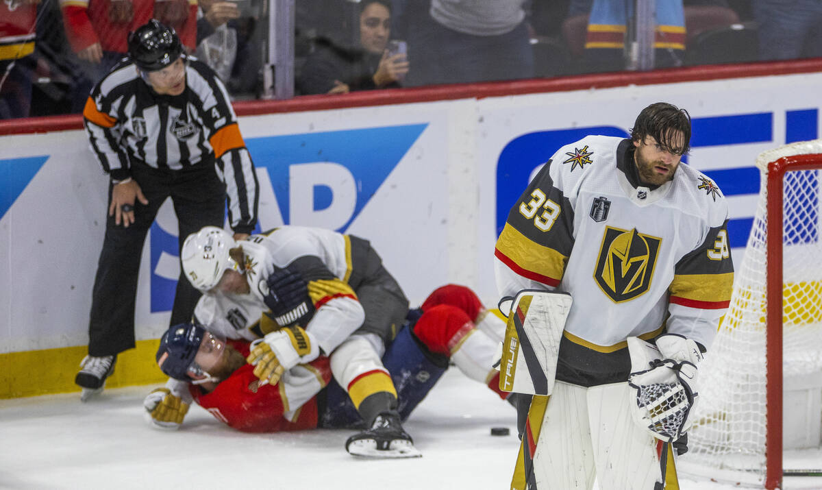 Golden Knights goaltender Adin Hill (33) looks dismayed as his teammates and the Florida Panthe ...