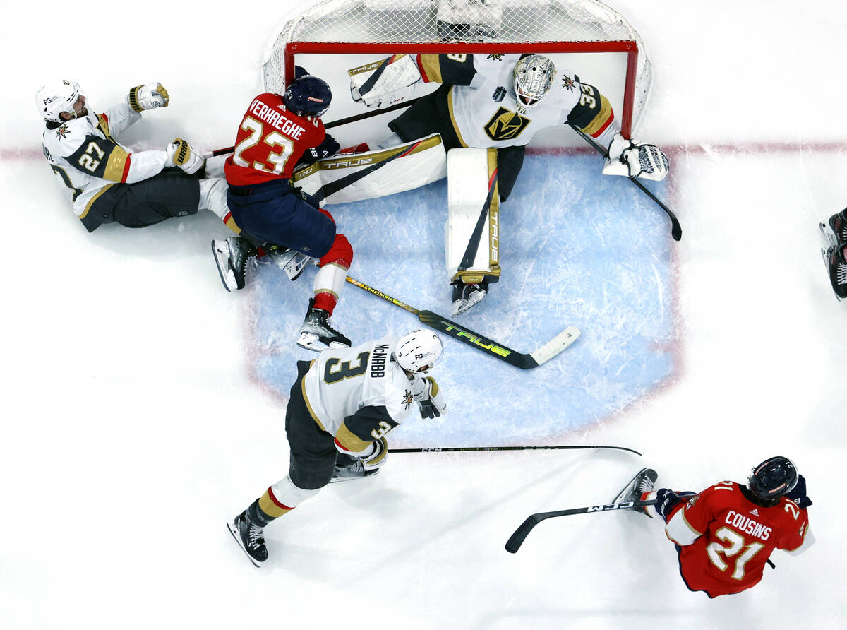 Golden Knights goaltender Adin Hill (33) is knocked into the net as Florida Panthers center Car ...
