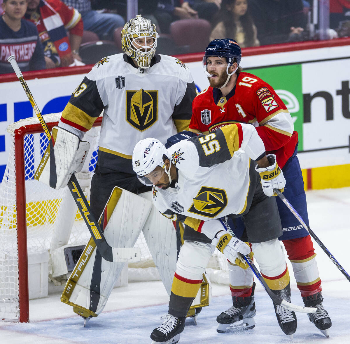Golden Knights right wing Keegan Kolesar (55) is pushed from behind by Florida Panthers left wi ...