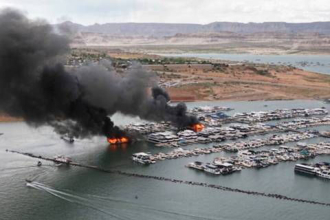 A houseboat fire is seen in Wahweap Marina on Lake Powell, Friday, June 2, 2023, near Page, Ari ...