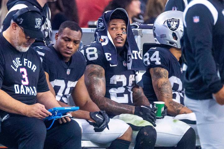 Raiders running back Josh Jacobs (28) sits on the bench during a change of possession against t ...
