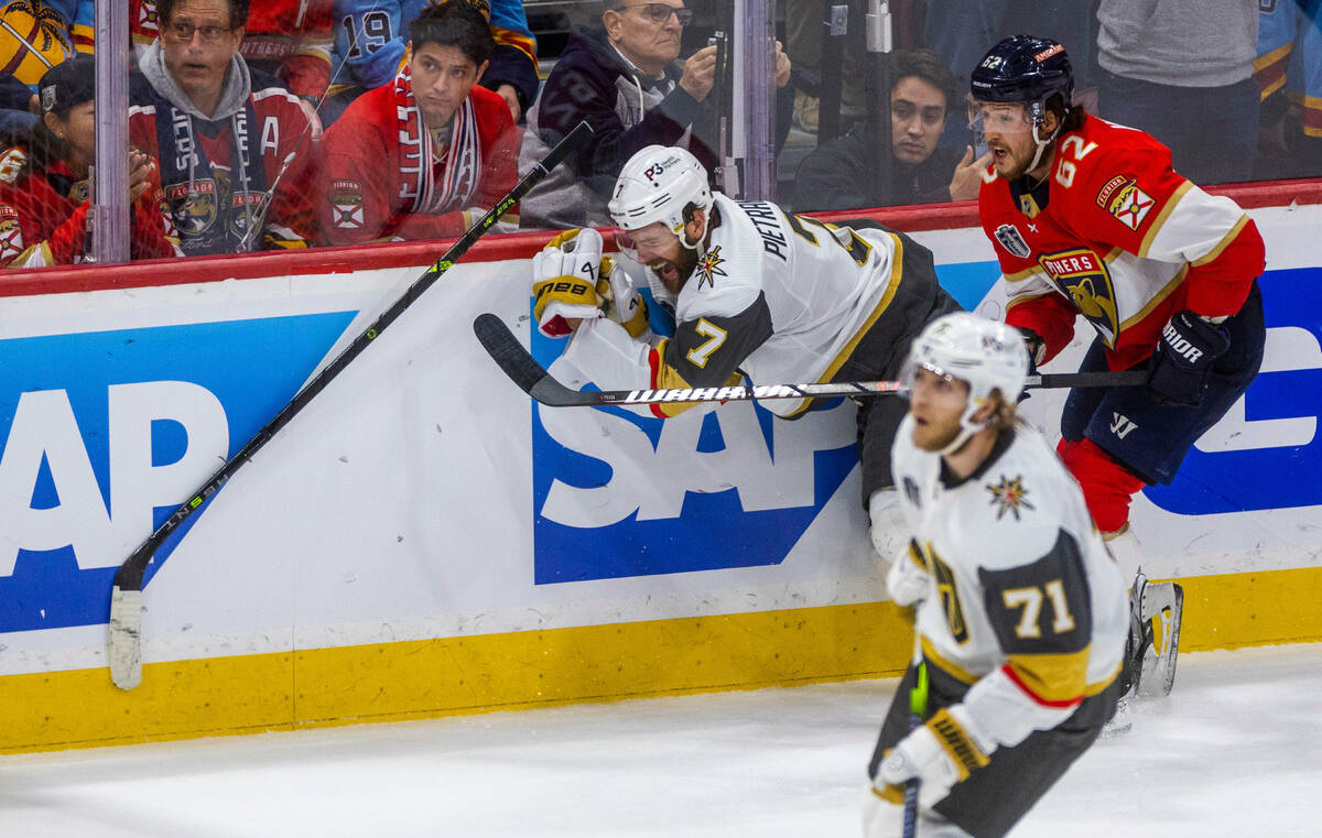 Golden Knights defenseman Alex Pietrangelo (7) is checked hard from behind by Florida Panthers ...