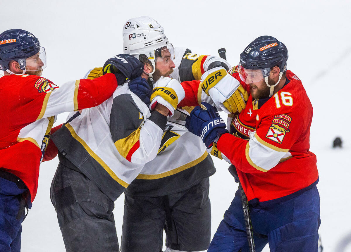 Golden Knights defenseman Alex Pietrangelo (7) fights with Florida Panthers center Aleksander B ...