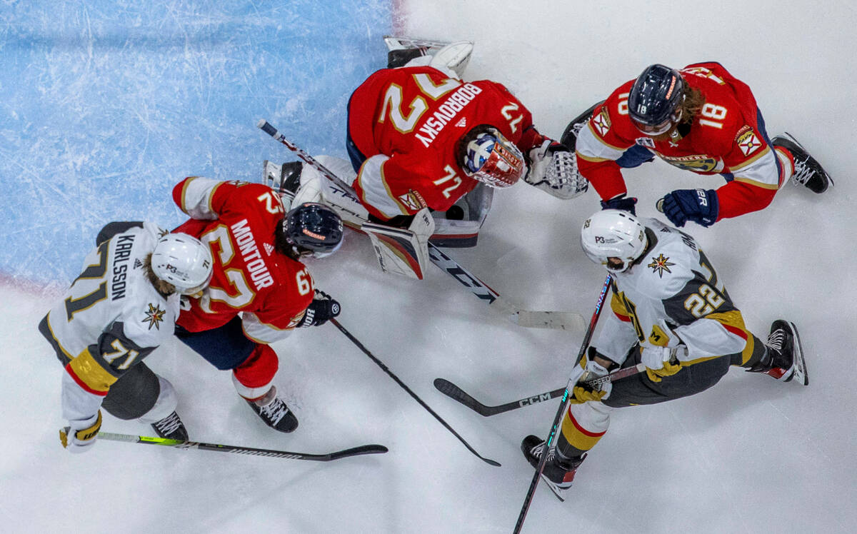 Florida Panthers goaltender Sergei Bobrovsky (72) traps the puck between his pads shot by Golde ...