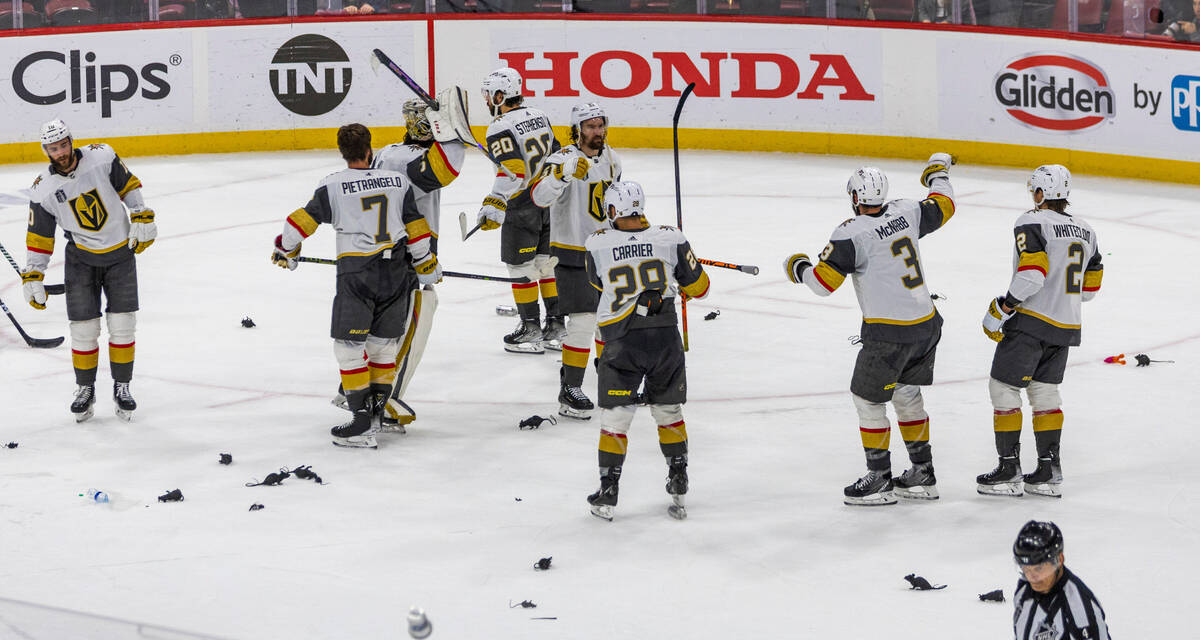 Golden Knights players celebrate their 3-2 win against the Florida Panthers as rats cover the i ...