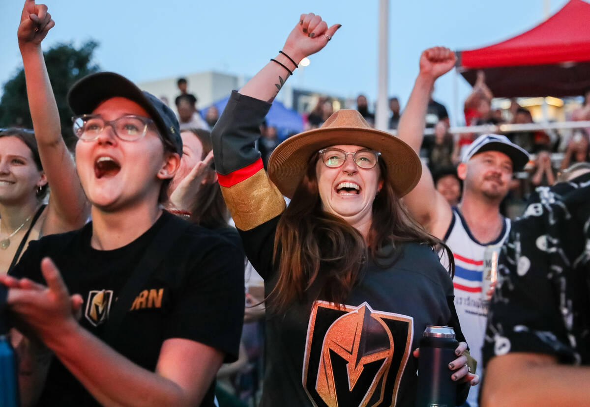 Fans celebrate the Golden Knights winning the Stanley Cup at the Water Street Plaza watch party ...