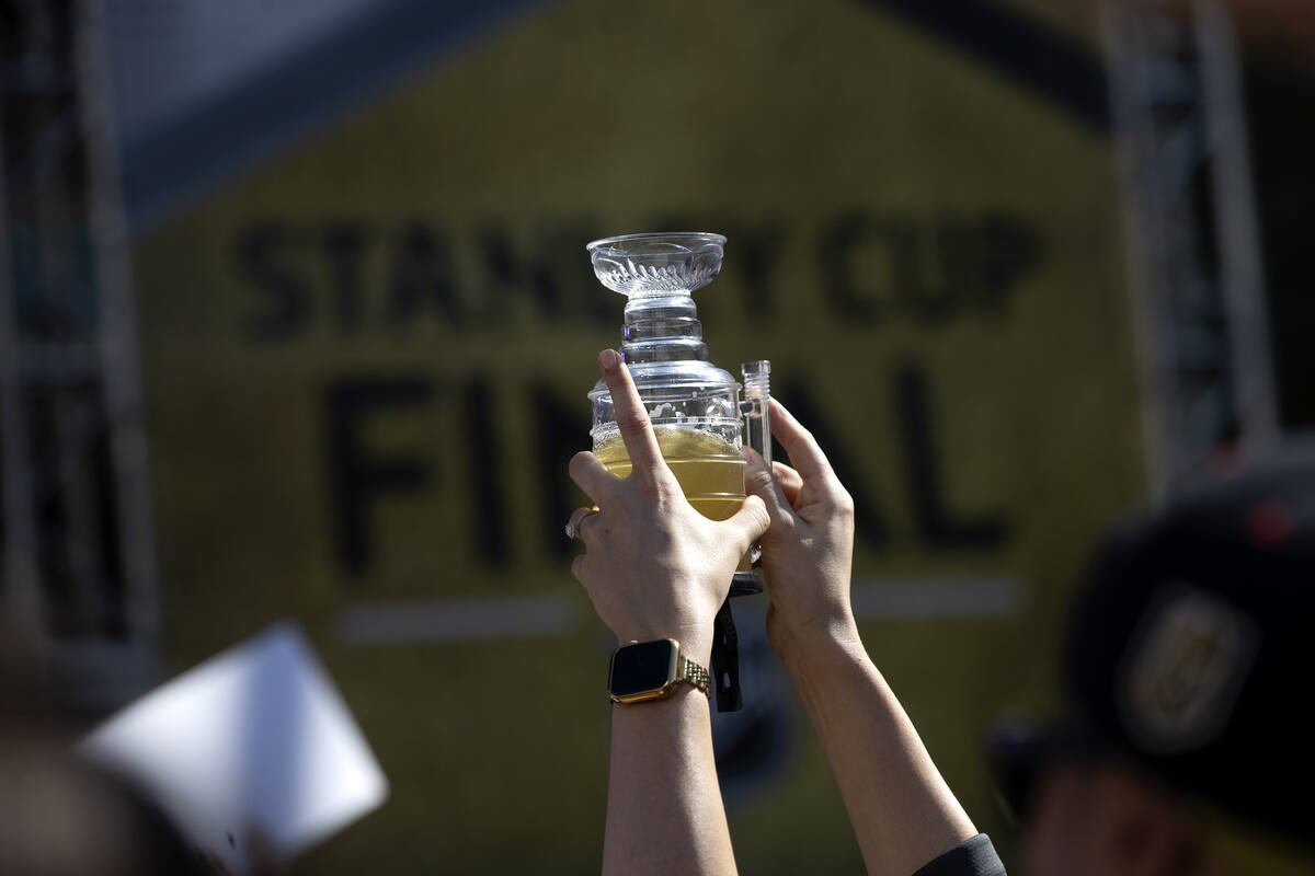 A Golden Knights fan holds up a Stanley Cup-shaped beer before Game 5 of the NHL hockey Stanley ...
