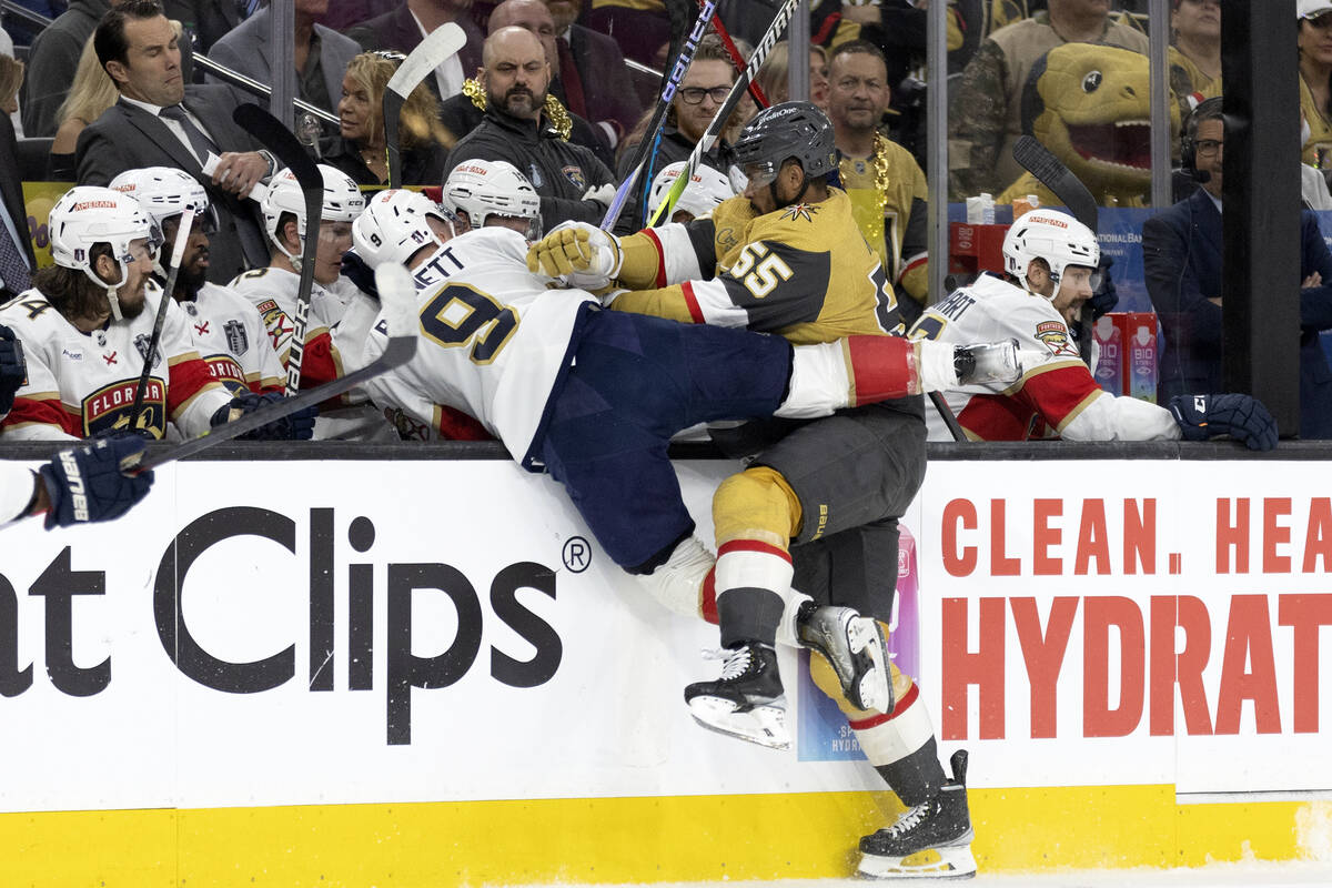 Golden Knights right wing Keegan Kolesar (55) slams Florida Panthers center Sam Bennett (9) int ...