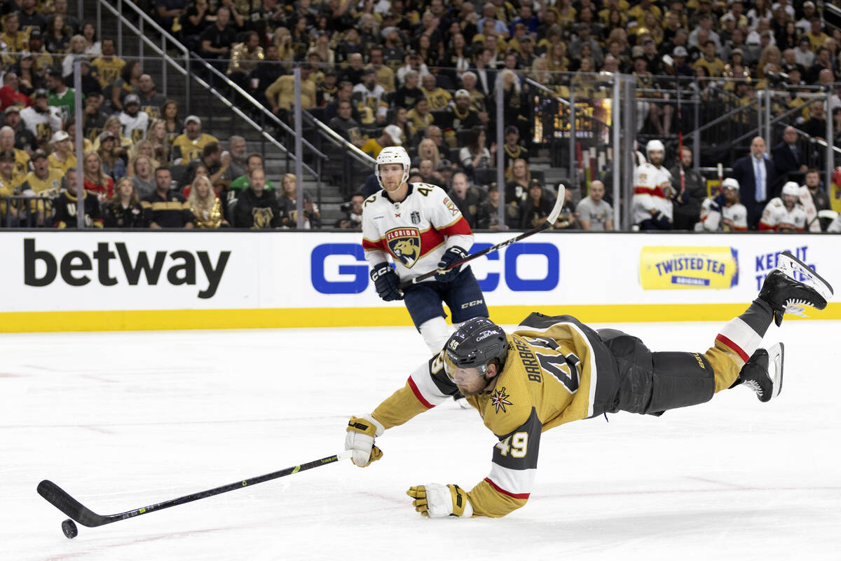 Golden Knights center Ivan Barbashev (49) dives to take a shot on goal during the third period ...