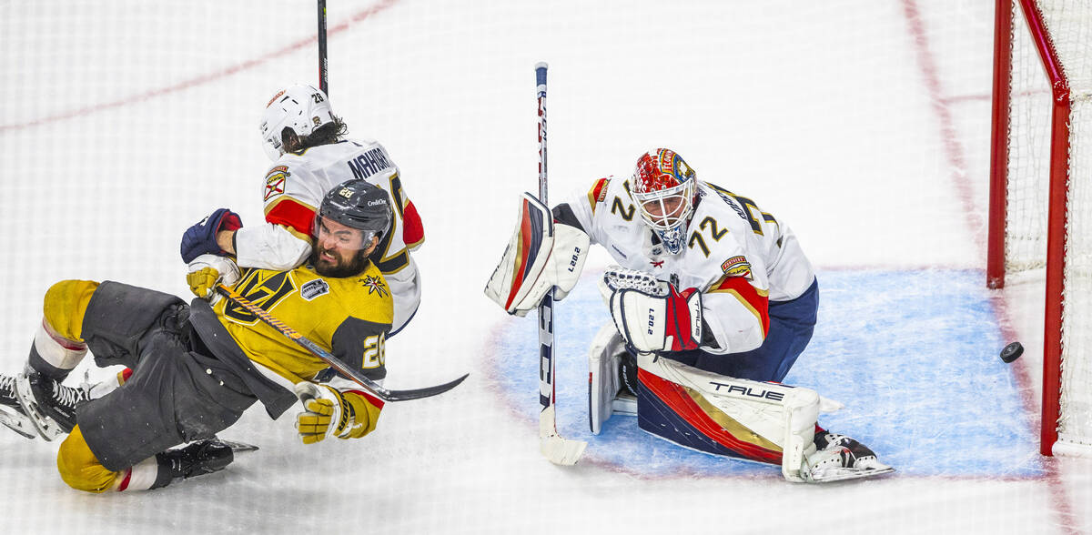 Golden Knights left wing William Carrier (28) is taken down by Florida Panthers defenseman Josh ...