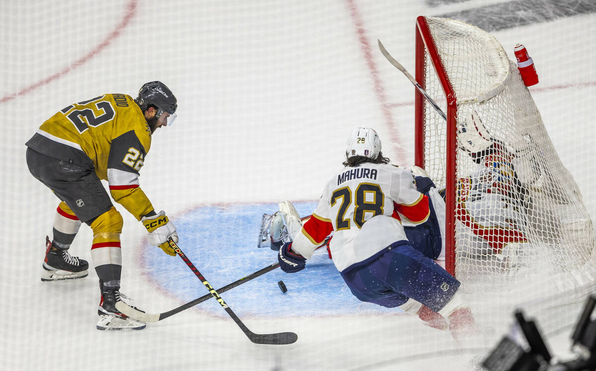 Golden Knights right wing Michael Amadio (22) gats past Florida Panthers defenseman Josh Mahura ...