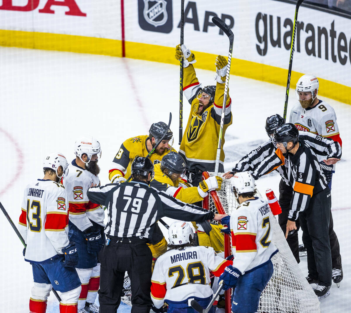 Golden Knights players celebrate a score over Florida Panthers goaltender Sergei Bobrovsky (72) ...