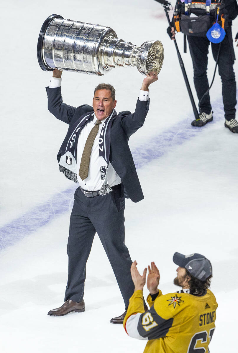 Golden Knights head coach Bruce Cassidy hoists the Stanley Cup after their 9-3 win over the Flo ...