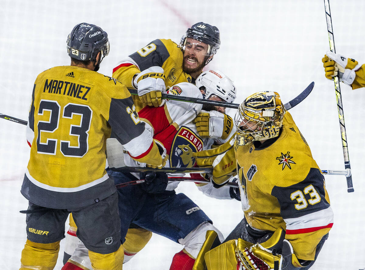 Florida Panthers defenseman Radko Gudas (7) is driven from the crease after a shot against Gold ...