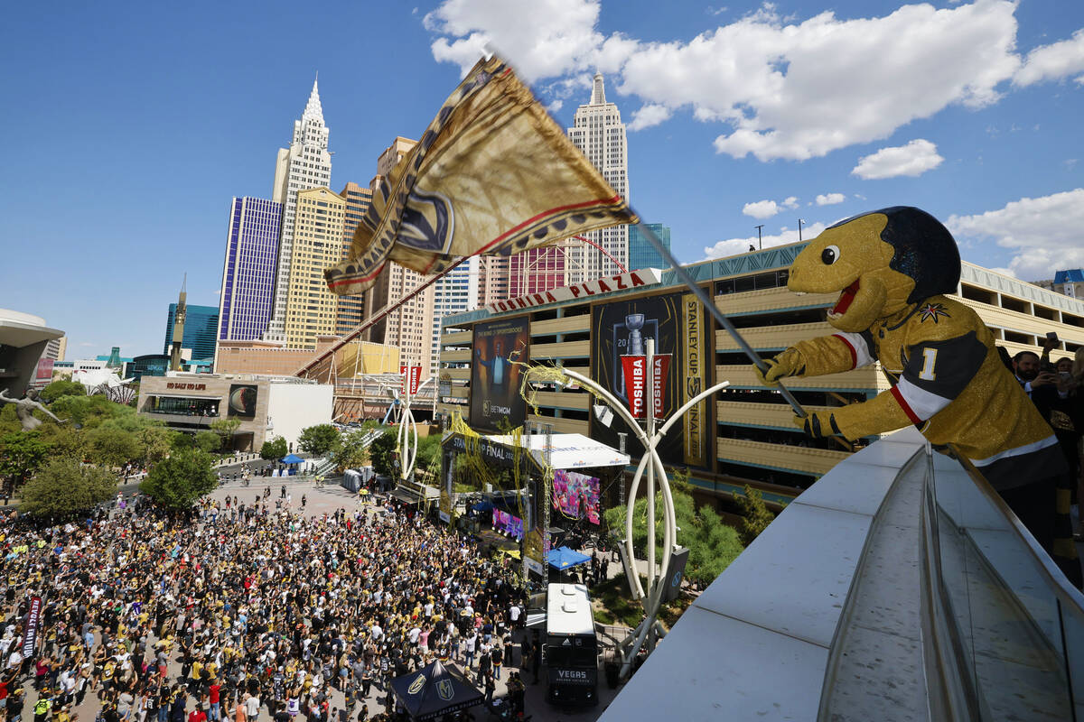 Vegas Golden Knights mascot Chance the Golden Gila Monster flies a flag as DJ Steve Aoki perfor ...