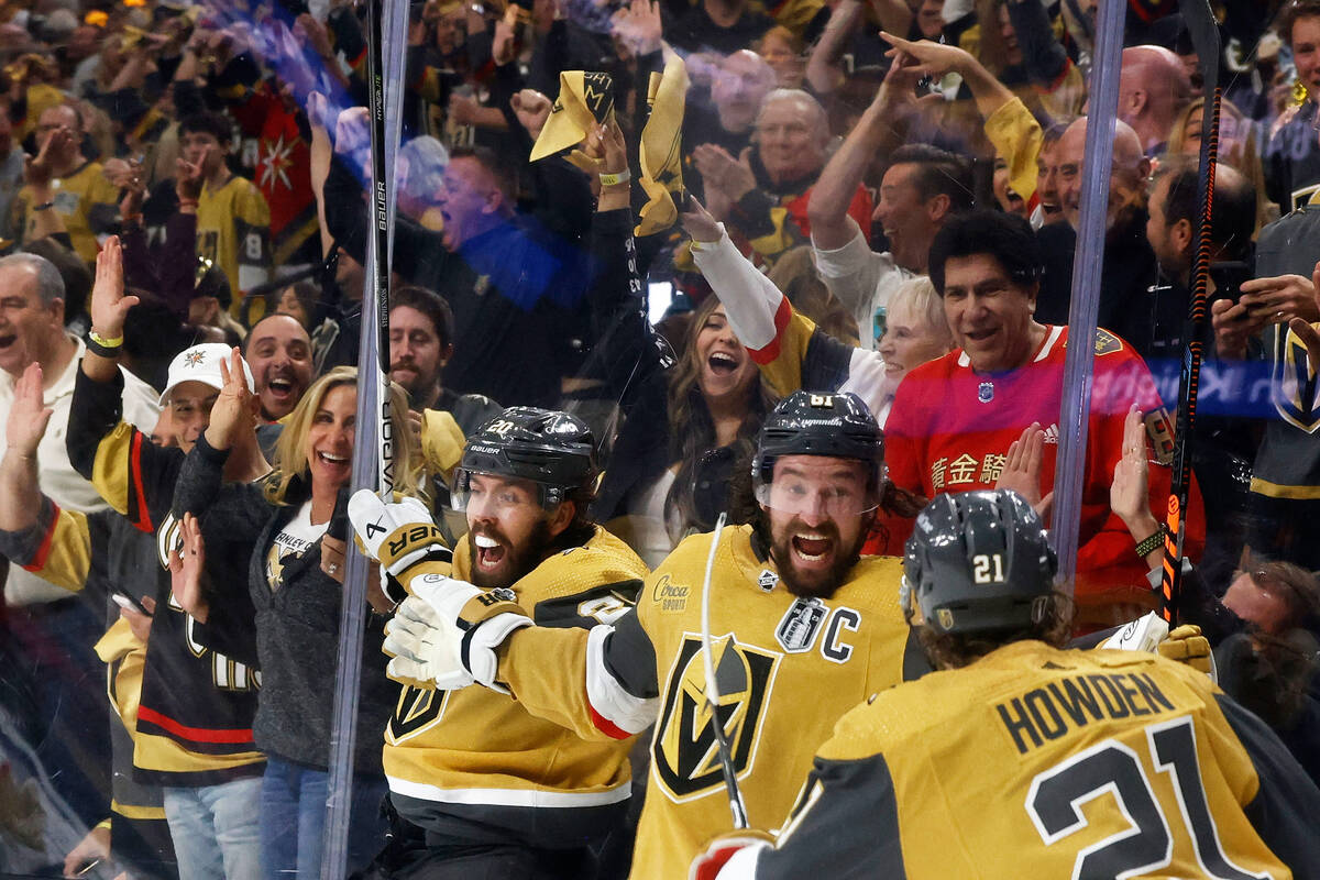Golden Knights right wing Mark Stone (61), center, celebrates with Golden Knights center Chandl ...