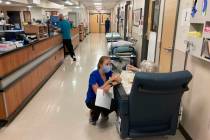 FILE - In this Aug. 20, 2021, file photo, a nurse talks to a patient in the emergency room at S ...