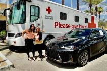 Sales consultants Krystal Reyes, left, and Sammy Gomez proudly display their “red badged arms ...