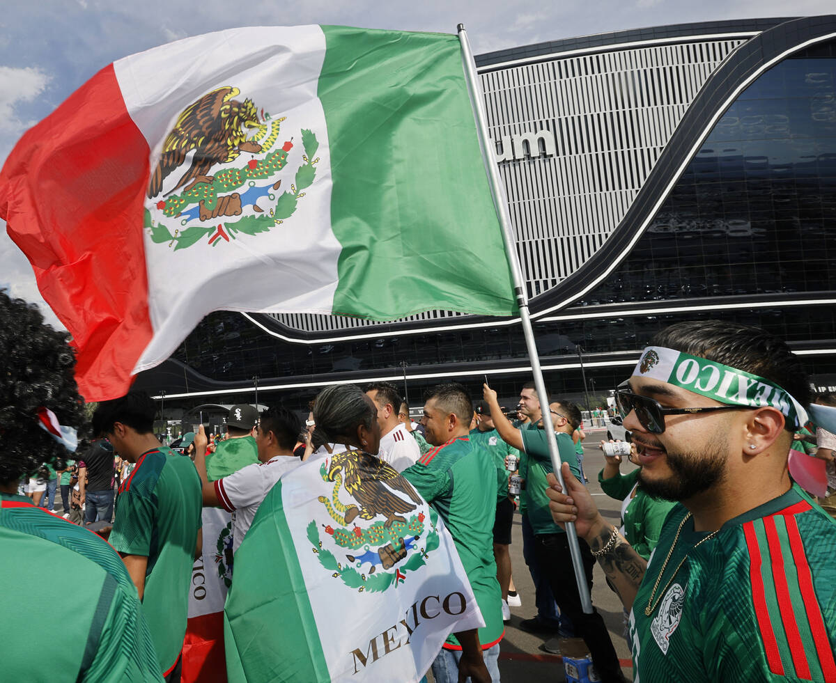 Mexico fan Miguel Angel Munoz of Las Vegas holds a Mexican flag outside the Allegiant Stadium, ...