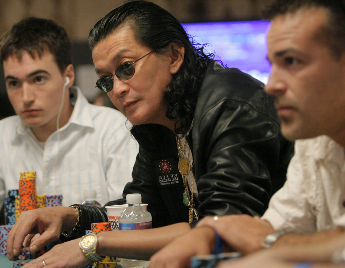 Professional poker player Scotty Nguyen, center, plays during the $10,000 buy-in main event of ...