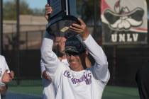 UNLV coach Owen Hambrook raises the Mountain West championship trophy at UNLV's Fertitta Tennis ...