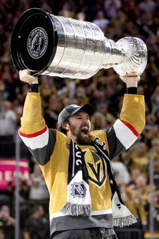 Golden Knights right wing and captain Mark Stone holds up the Stanley Cup after winning Game 5 ...